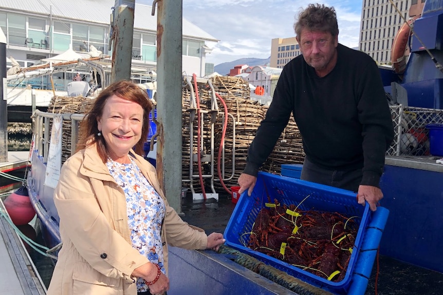 A woman buys crayfish straight off a boat 