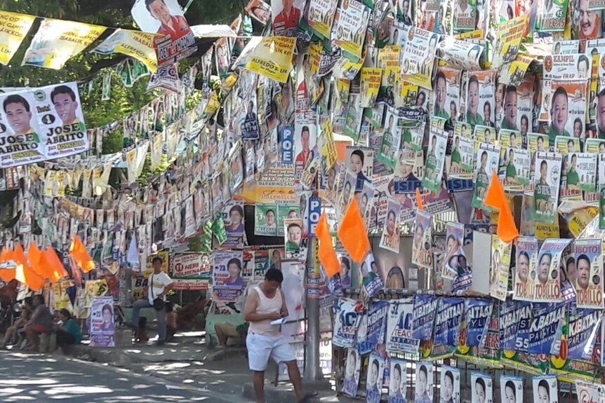 Posters hang on the streets of Manila for election candidates.