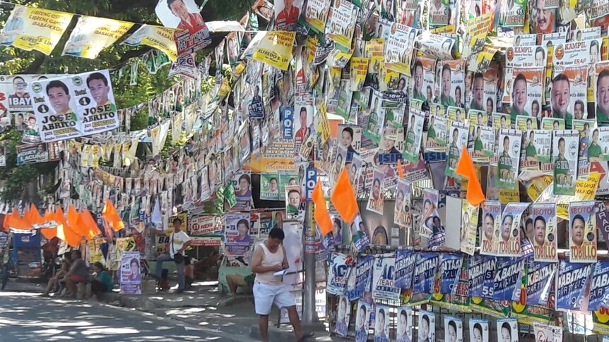 Posters hang on the streets of Manila for election candidates.