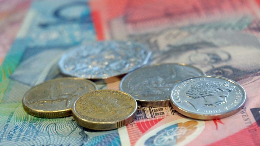 Australian gold and silver coins on top of Australian notes.