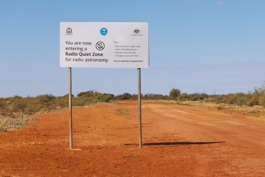 A sign along a gravel road indicating a quiet radio zone.