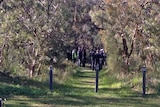 Police and members of the court visit the burial site in Kings Park.