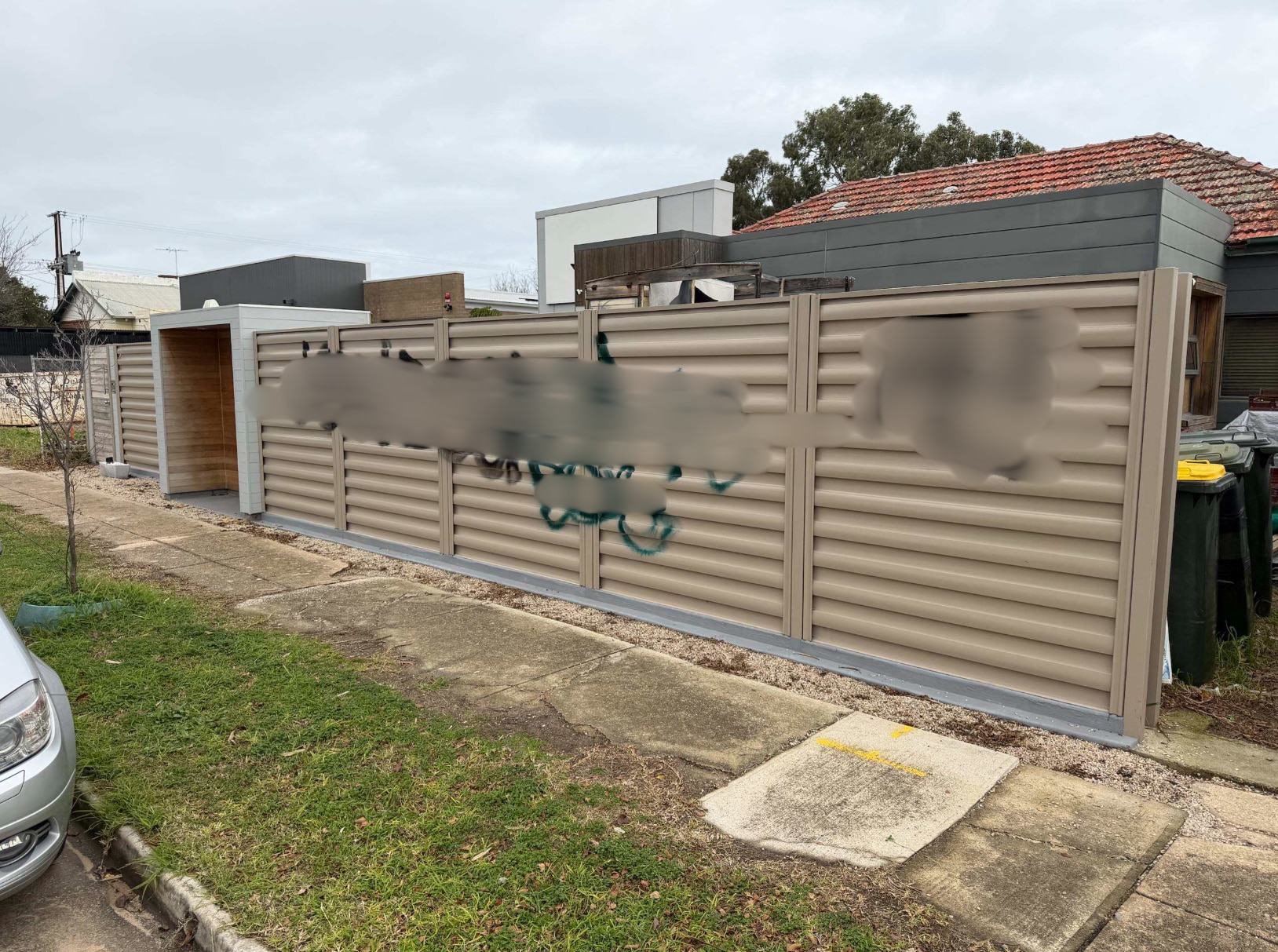 a fence with large graffiti on it