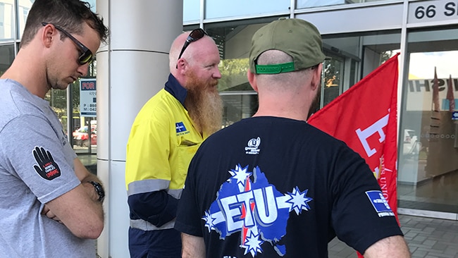 Some of the workers laid off from the Ichthys project in Darwin protest outside the office of engineering firm Laing O'Rourke.