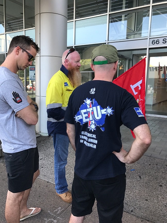 Some of the workers laid off from the Ichthys project in Darwin protest outside the office of engineering firm Laing O'Rourke.