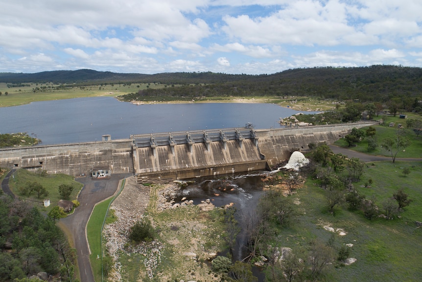 Wide aerial photo over the Leslie Dam wall and across the water reservoir.