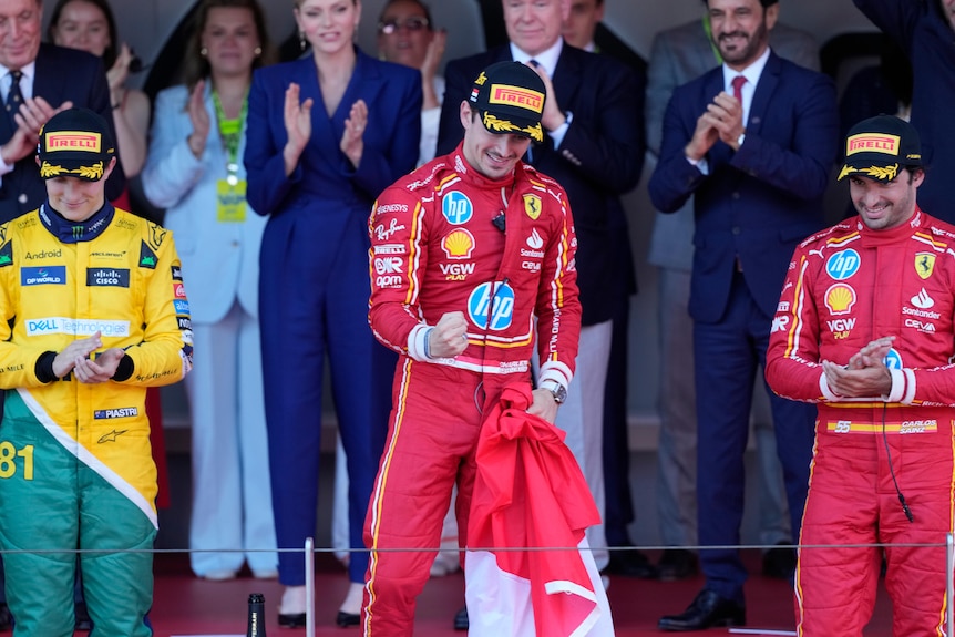 Oscar Piastri, Charles Leclerc and Carlos Sainz standing on the F1 podium in Monaco