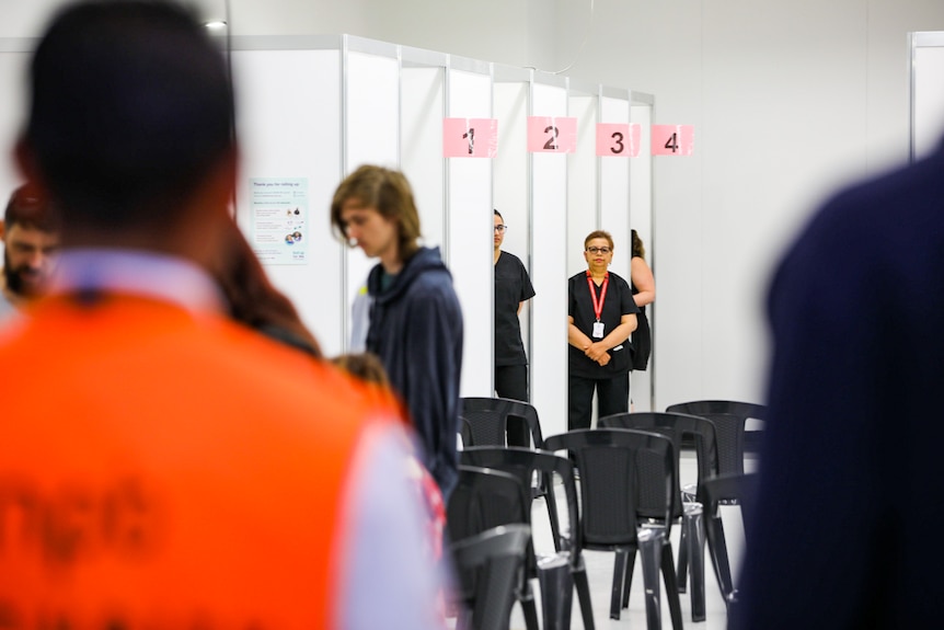 A nurse waiting outside a COVID-19 vaccine booth.