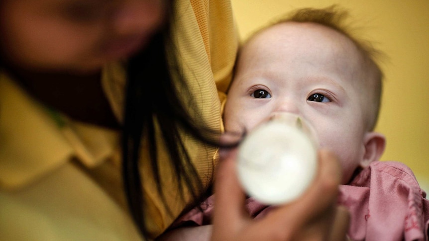 Baby Gammy is fed by his surrogate mother Pattaramon Janbua.