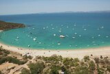 An fleet of boats, kayaks and jet skis take to the waters off Great Keppel Island