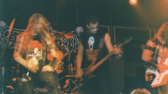 Photo of metal band performing on stage. 