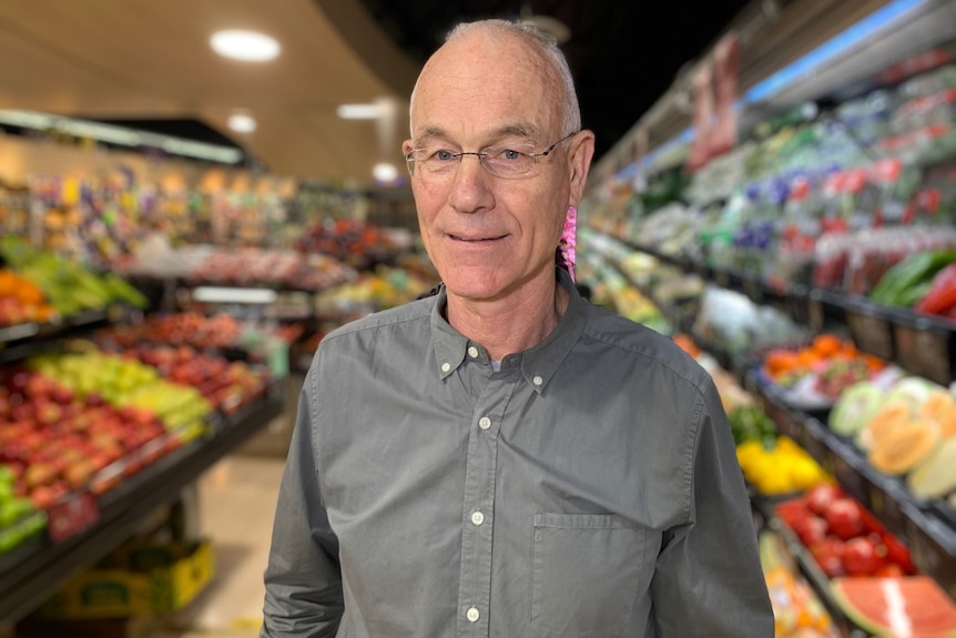 A man standing in a grocery shop.