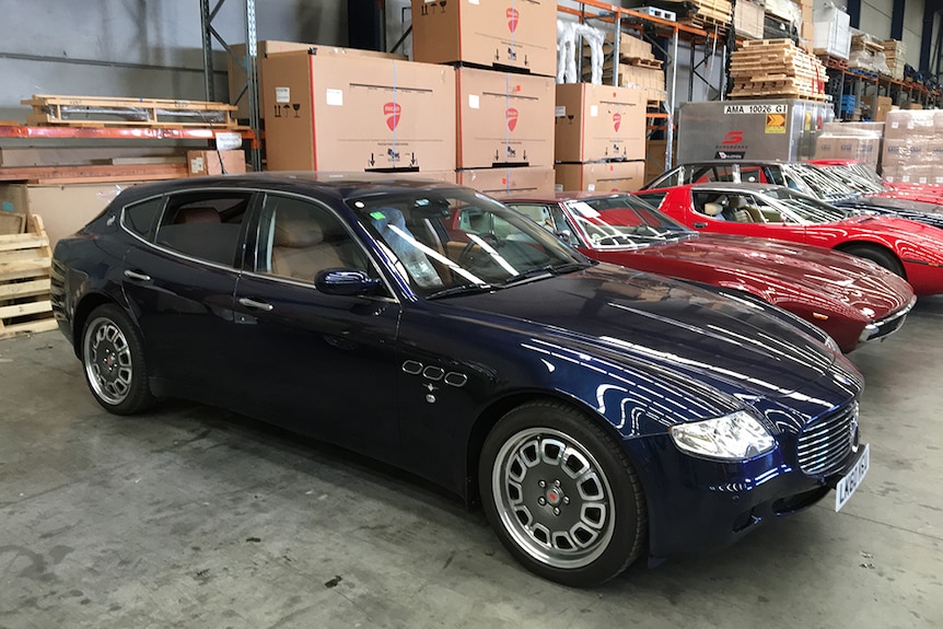 Sports cars parked in warehouse.