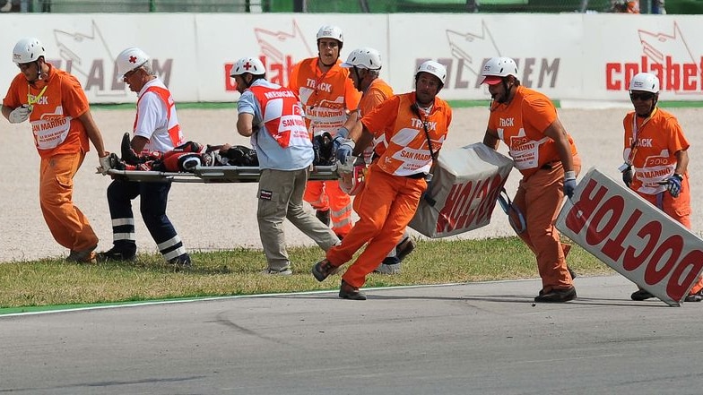 Medical staff carry Shoya Tomizawa from the track on a stretcher. He later died in hospital