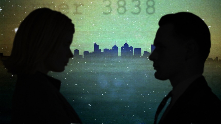 The silhouette of a woman and a man are shown in front of the Melbourne skyline.