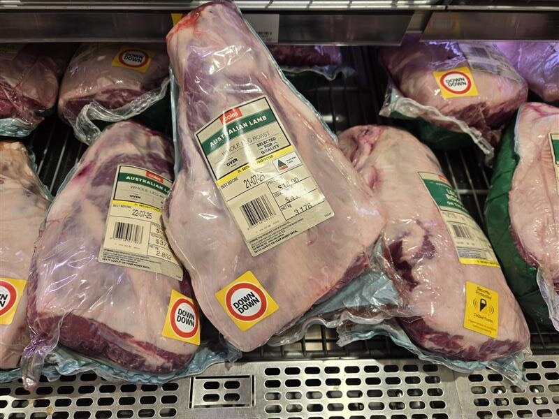 Wrapped lamb legs in a display cabinet.