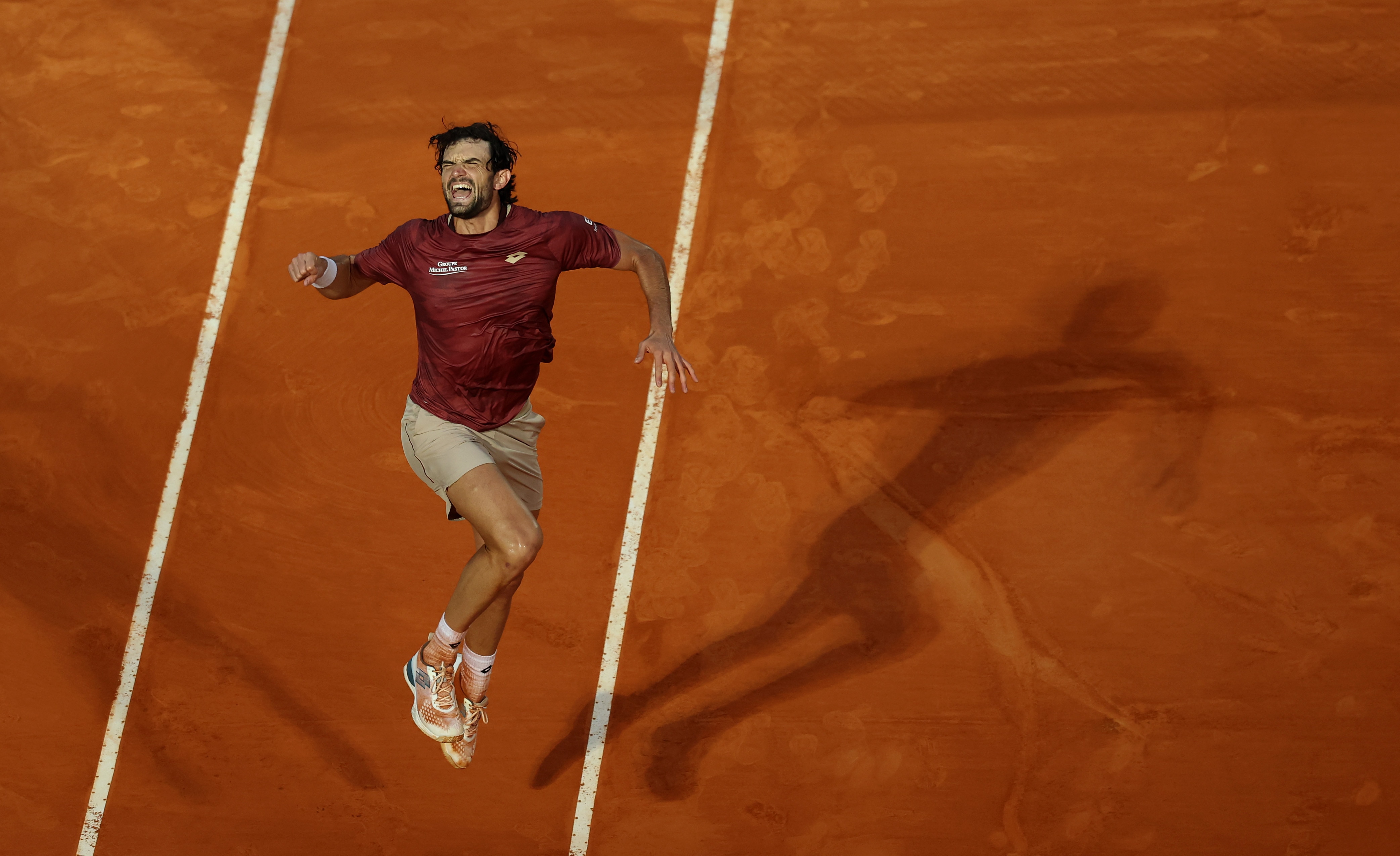 Valentin Vacherot jumps and punches the air after winning a match at the Monte Carlo Masters.