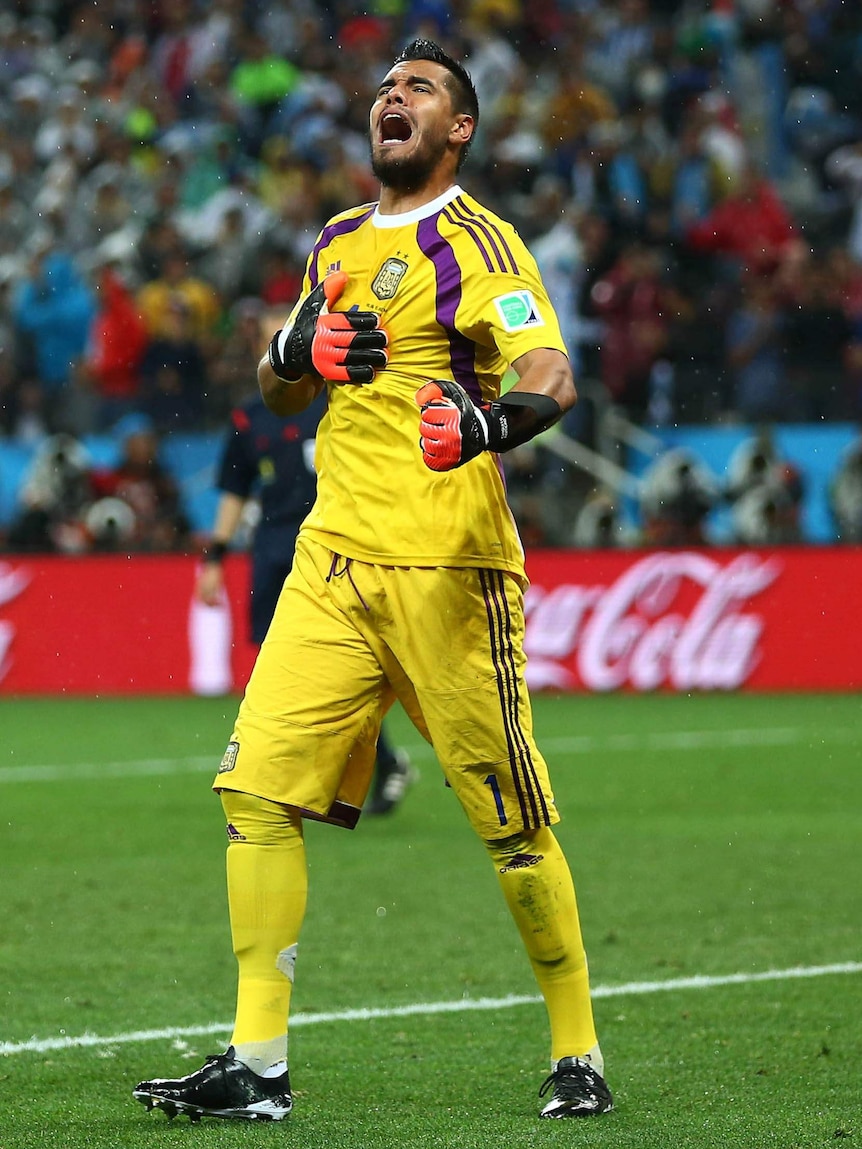 Argentina's goalkeeper Sergio Romero celebrates saving the penalty from Ron Vlaar against the Netherlands.
