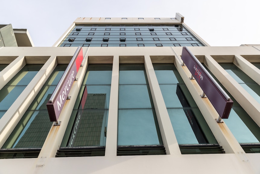 An angled shot of the exterior of the Mercure Hotel in Perth, looking upwards towards the sky.