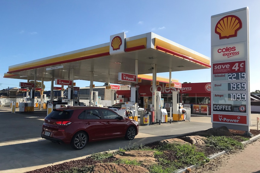 Wide shot of a Shell service station, showing unleaded petrol at 221.9 cents a litre.