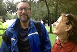 A couple laughs after being rescued from floodwaters.