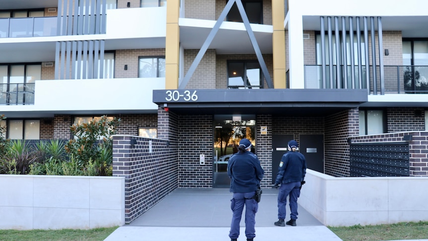 police stand at unit entrance