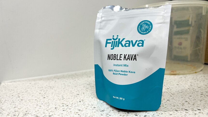 A plastic packet containing kava sits on a kitchen counter.