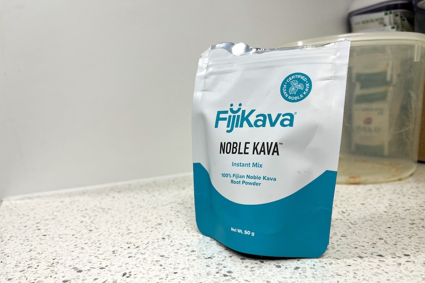 A white and blue packet with the label "FijiKava" and "Noble Kava" sitting on a kitchen counter.
