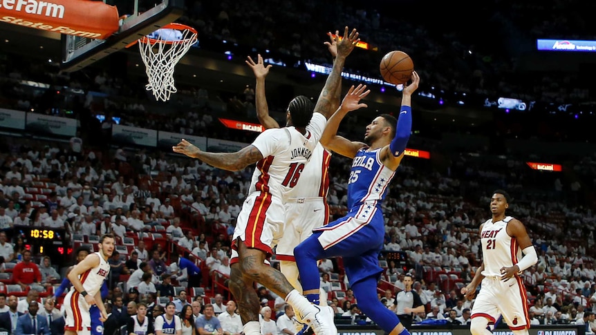 Ben Simmons shoots for the basket against the Heat