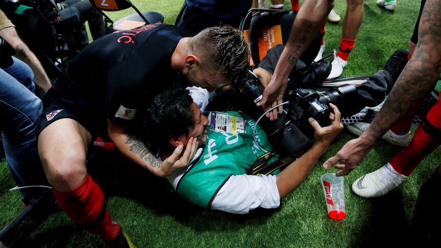Croatia players hug stricken photographer