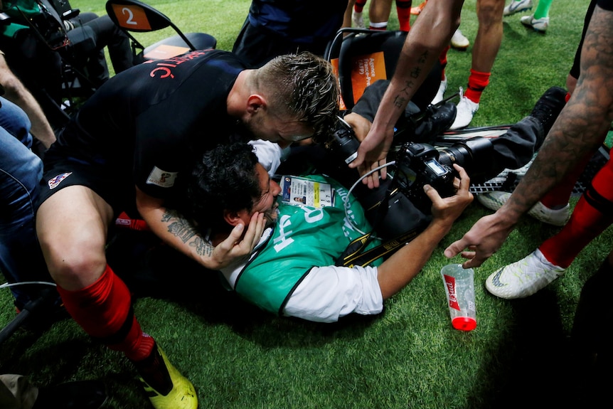 Croatia players hug stricken photographer