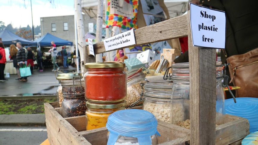 a crate of different sized bottles and jars