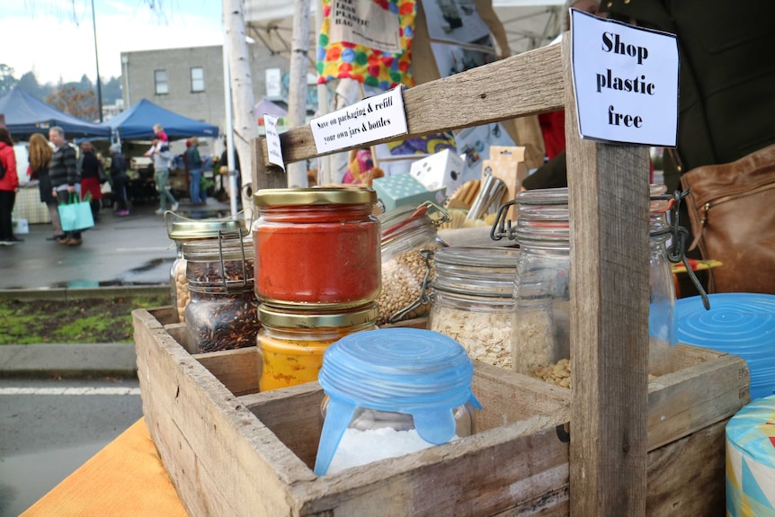 a crate of different sized bottles and jars