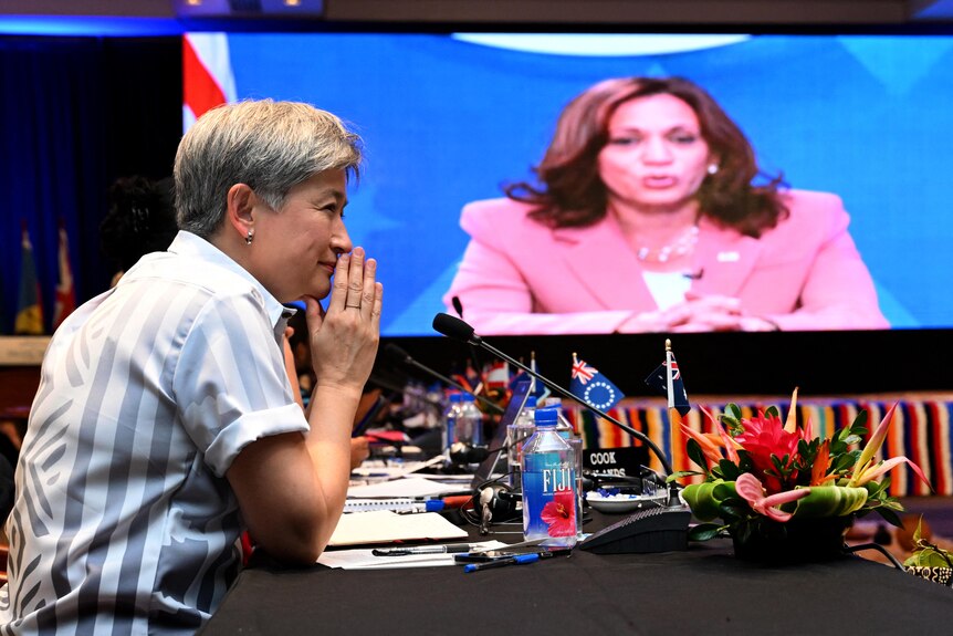 Penny Wong listens to US Vice-President Kamala Harris speaking via video-link to the Pacific Islands Forum.