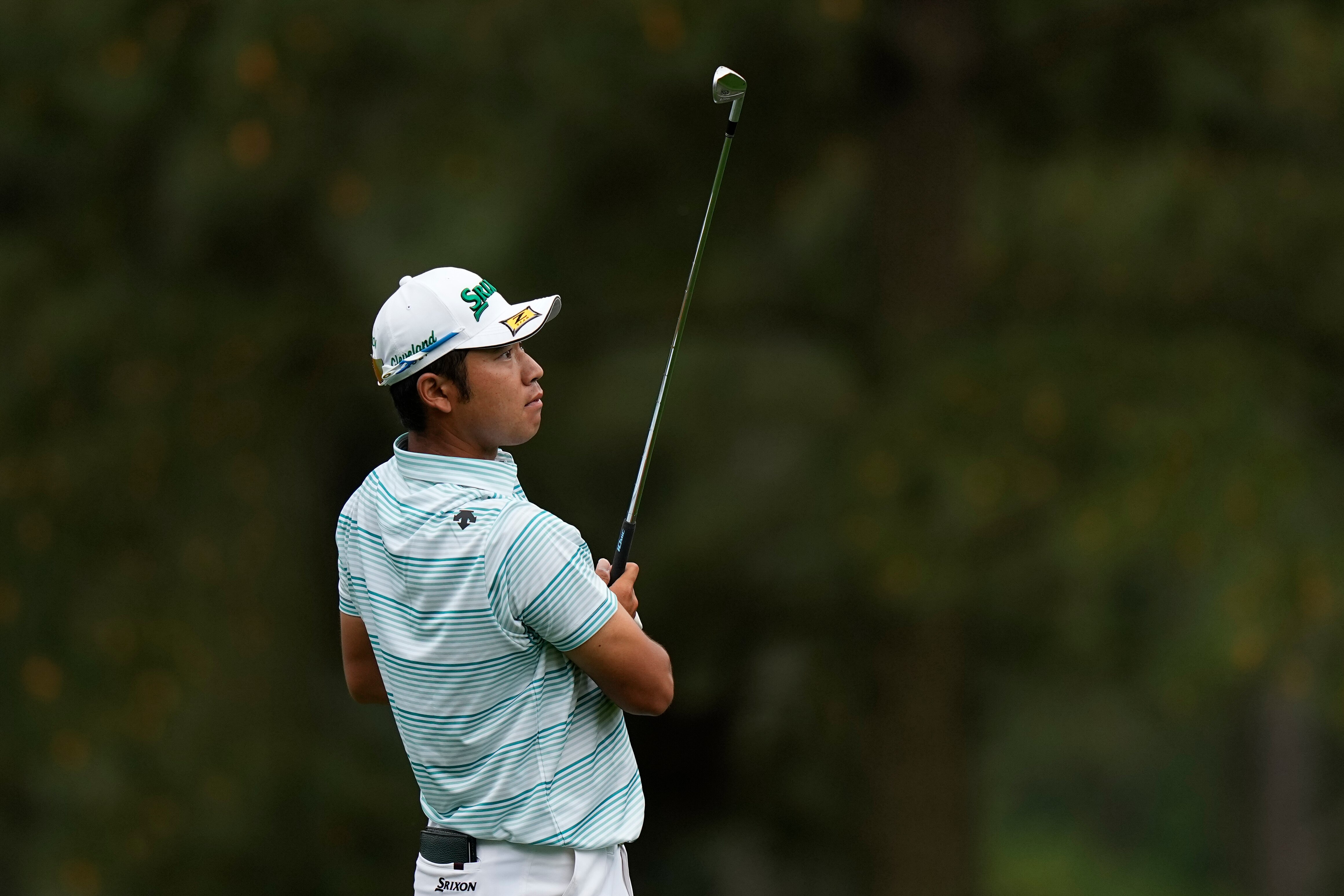 Hideki Matsuyama looks up after completing a shot