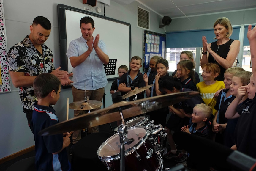 Guy Sebastian with student drummer