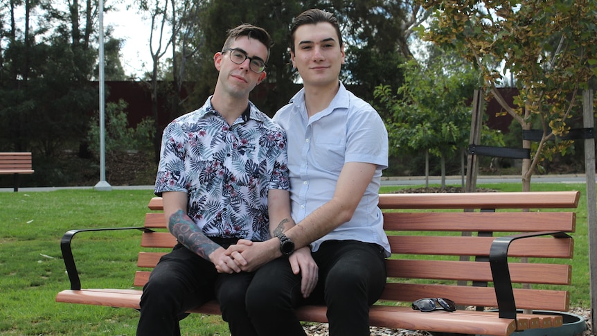 Two men sitting on a park bench together