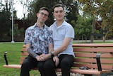 Two men sitting on a park bench together