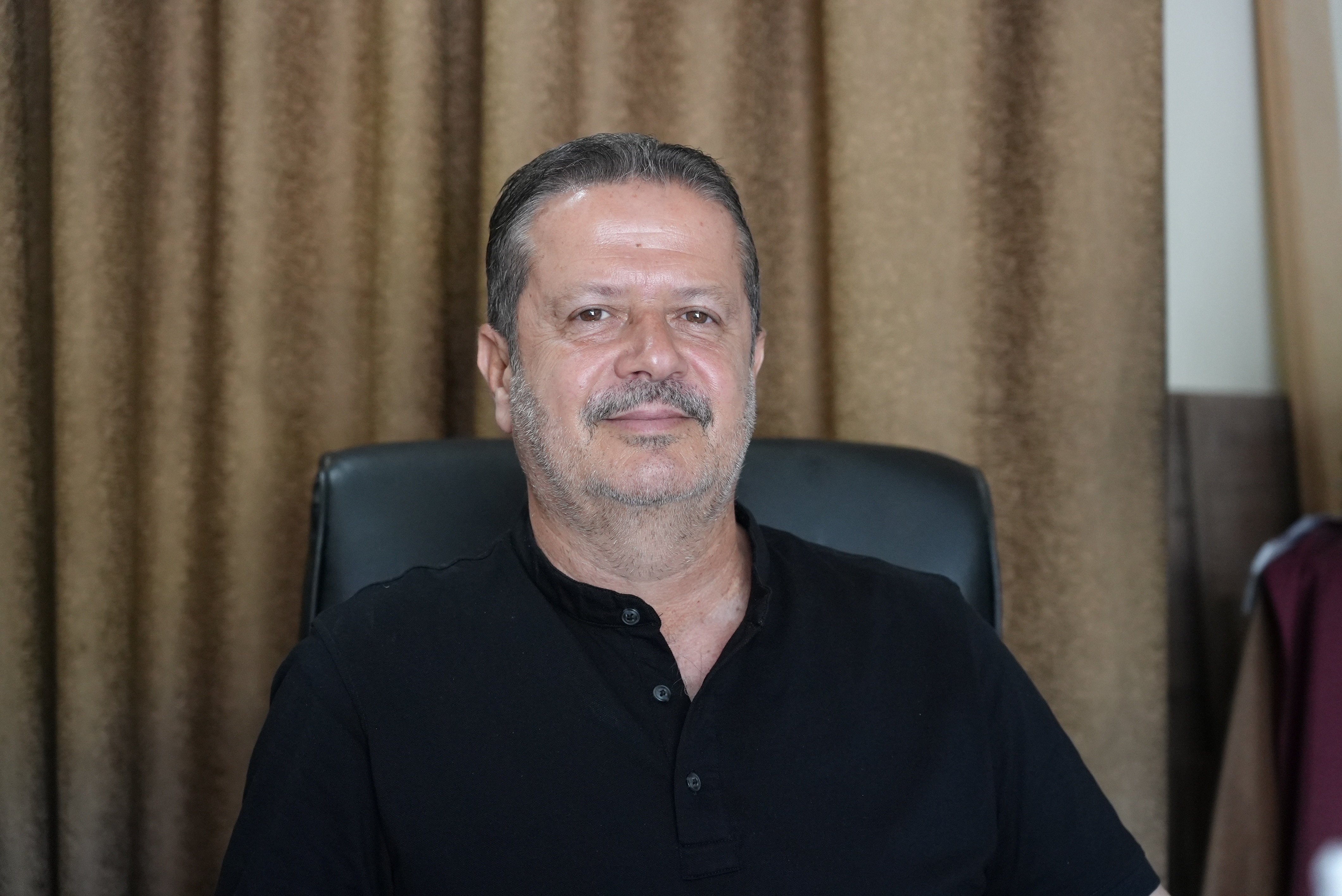 A close up of a Lebanese man wearing a black shirt.