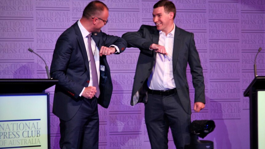 ACT Labor leader Andrew Barr and Canberra Liberals leader Alistair Coe bump elbows on stage.