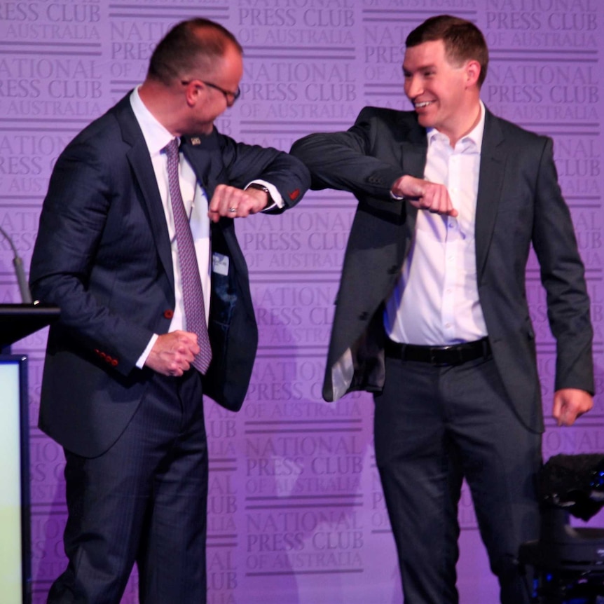 ACT Labor leader Andrew Barr and Canberra Liberals leader Alistair Coe bump elbows on stage.