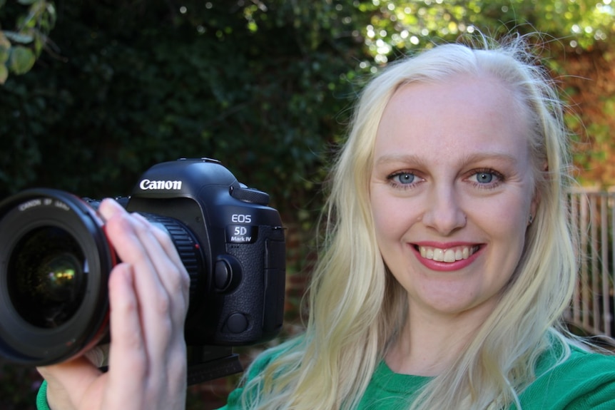 Former ballet dancer Sophie Bender holds a camera