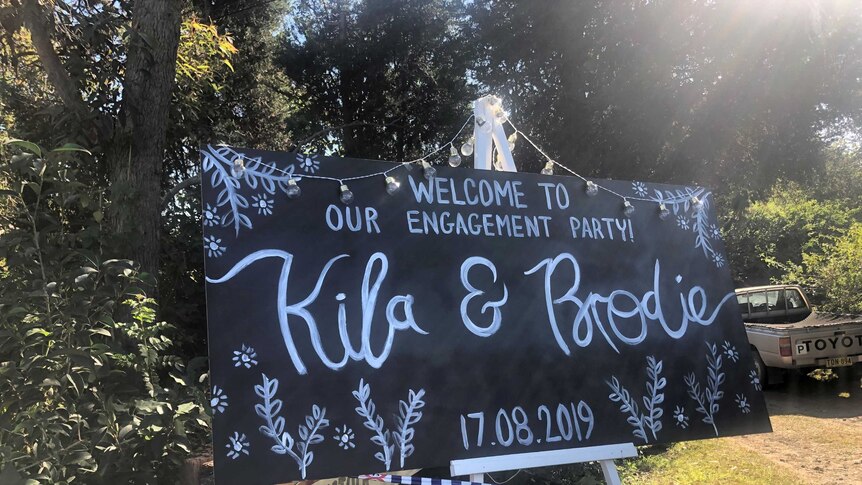 Signage welcoming engagement party.
