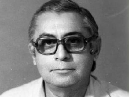 A black and white photo of an older man wearing glasses.