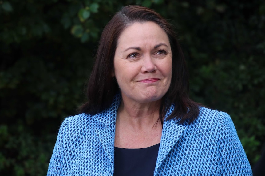 A close up of Liza Harvey standing in a green garden at Parliament House in Perth.