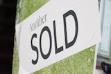 White banner saying "another sold" following house sale