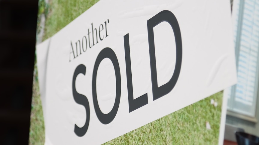 White banner saying "another sold" following house sale