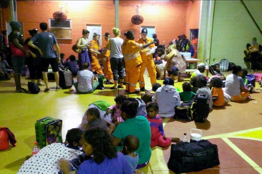 A group of people and emergency service personnel.
