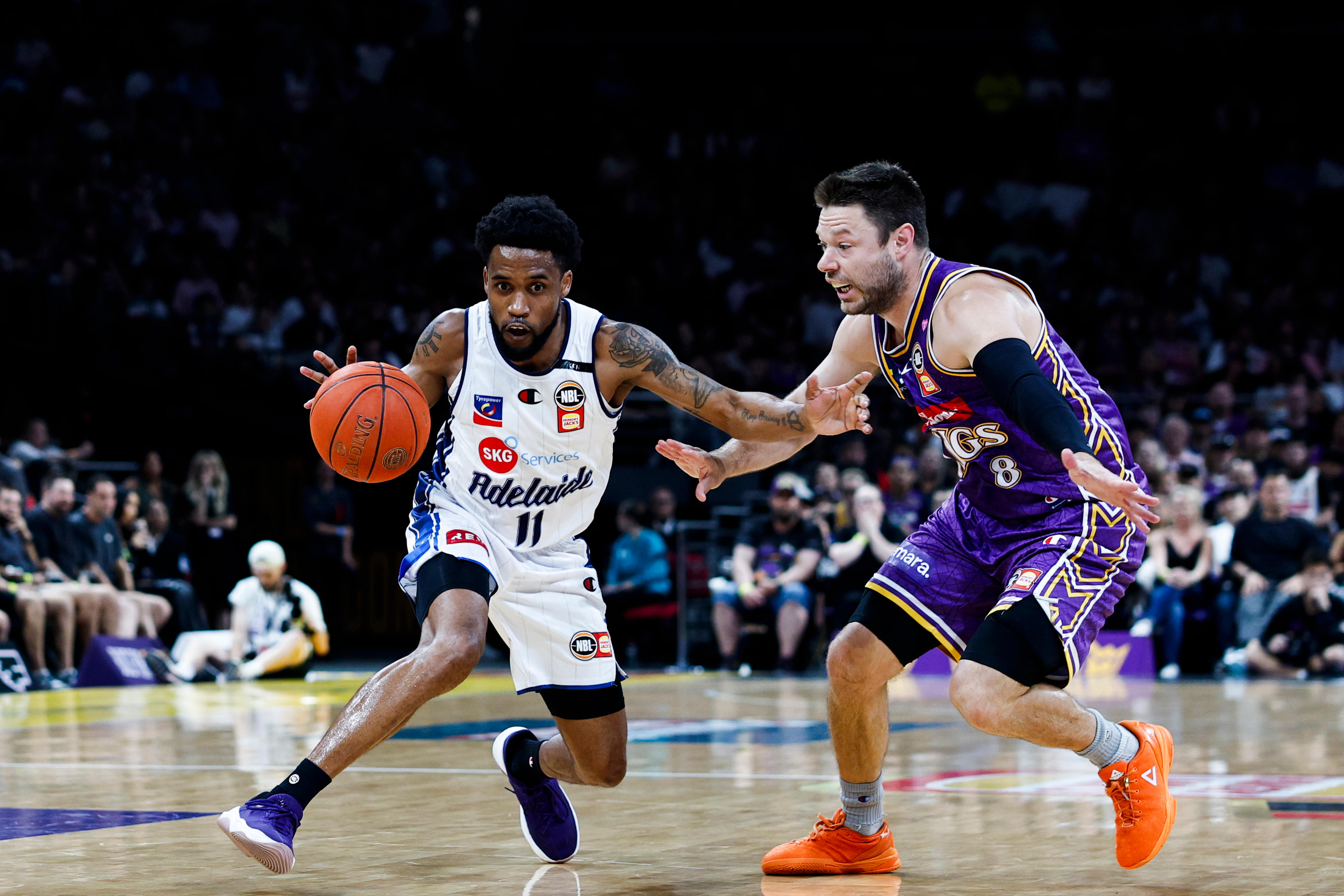 Bryce Cotton dribbles the ball for the 36ers as the Kings' Matthew Dellavedova defends in the NBL Championship Series opener.