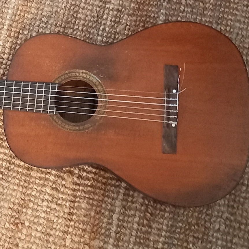 a slightly worn and aged acoustic guitar